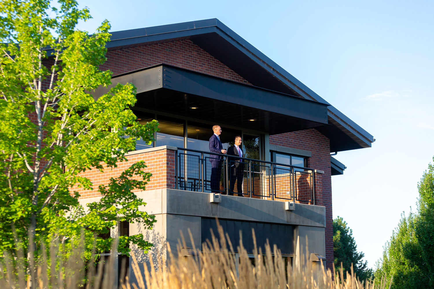 Our partners Tyler and Josh standing on the balcony of our Bend office building