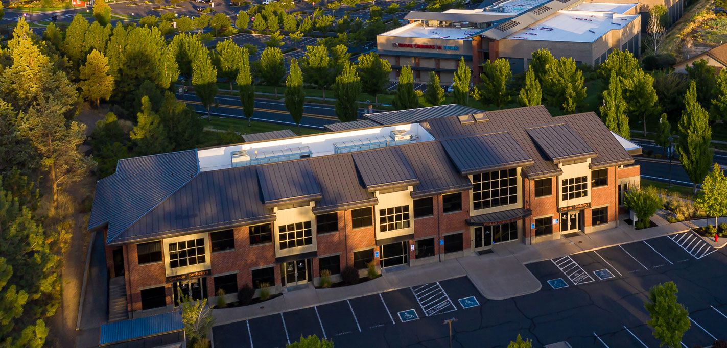 An arial view of our Bend office location and parking lot during late afternoon