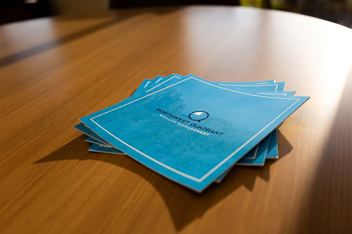 Northwest Quadrant Wealth Management brochures stacked on a conference table